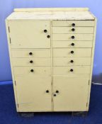Vintage dentist's cabinet with an arrangement of ten drawers and three cupboards, some glass