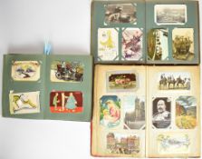 Three Edwardian postcard albums including topographical, humorous, transport and military,