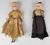 Two late Victorian 'Pumpkin-Head' dolls, both with black glass eyes and wooden limbs, tallest 34cm.