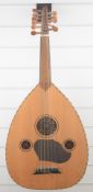 Arabic six-paired stringed oud, the bowl back with laminated mahogany sections, length 61cm, in soft