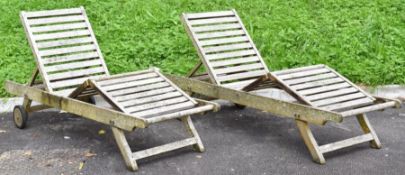 Pair of teak garden loungers with recline function, adjustable leg rest and side shelf and cushions,