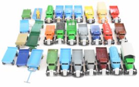 A collection of twenty one vintage Dinky Toys die cast model flat bed trucks and tankers together
