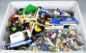 A large collection of loose and partially built Lego comprising bricks from mostly modern kits