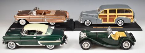 Four 1:18 scale diecast model cars including Maisto 1948 Chevrolet Fleetmaster (Woody).