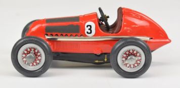 Schuco Studio 1050 clockwork tinplate racing car with red body, brown interior and silver hubs.