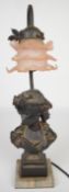 Bronze and marble table lamp, the base formed as a woman, with floral pink glass shade above, height