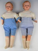 Two Reinische Gummi celluloid headed dolls with stuffed cloth body, glass eyes and composite