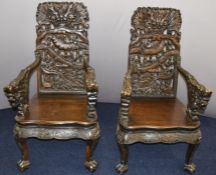Pair of Chinese carved hardwood chairs with serpentine fronts, pierced dragon decoration and