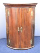 Georgian mahogany bow fronted corner cupboard, W75 x H108cm
