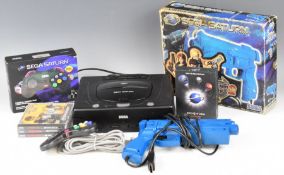 Sega Saturn retro video game console with power supply, boxed wireless controller, light guns and