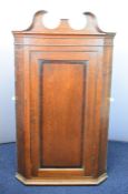 19thC oak corner cupboard with shaped pediment and three shelves within, W85 x H155cm