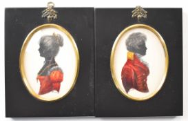 Pair of Turville silhouette portrait miniatures of a lady and gentleman with red clothing and gilt