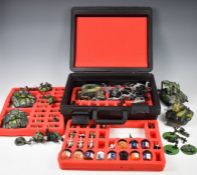 A collection of Games Workshop Warhammer and Warhammer 40K miniatures together with carry case, rule