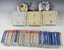 Three Sega Dreamcast retro video game consoles 1 NTSC J and 2 PAL versions together with 2