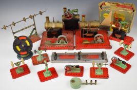 Four Mamod stationary live steam engines together with a collection of line shaft tools.