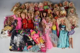 Twenty-five 1970's & 80's Barbie and Sindy dolls together with a collection of clothing and
