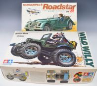 Tamiya Wild Willy M28 1:10 scale radio control stunt vehicle kit 5835 together with an LS 1:16 scale