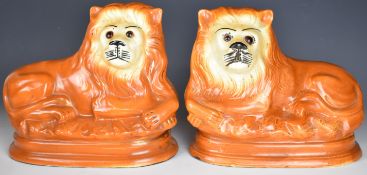 Pair of Staffordshire recumbent lions, length 30cm x height 30cm