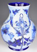 Moorcroft pottery pedestal baluster trial vase decorated in the Florian pattern, signed by Emma