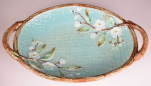Late 19thC two handled oval majolica dish with floral decoration, length 38cm