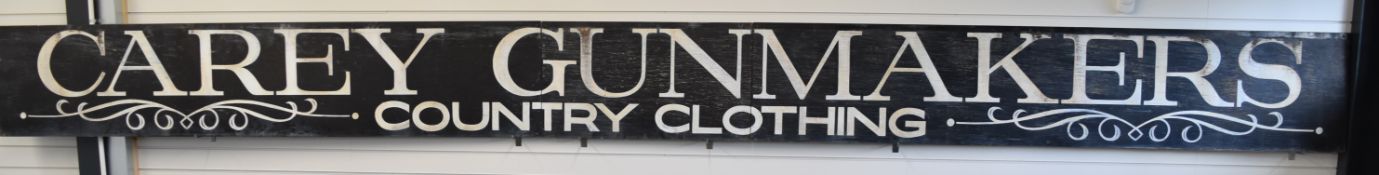 Carey Gunmakers Ltd Country Clothing wooden shop sign, 576x49cm.