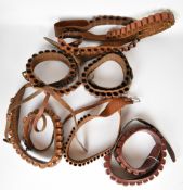 Seven leather shotgun cartridge belts including .410 and 12 bore.