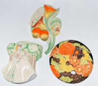 Clarice Cliff for Newport Pottery two Art Deco wall pockets and a plaque, tallest 26cm