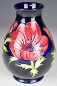 Moorcroft pottery pedestal vase decorated in the Anemone pattern, height 20cm