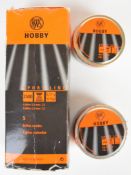Seven sealed tins of RWS Hobby .22 air rifle pellets, some in original box.