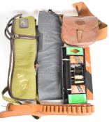 A collection of shotgun or rifle accessories comprising two gun slips, leather cartridge bag,