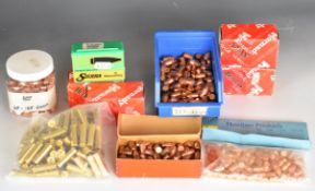 A large collection of rifle bullet heads and empty cartridge cases including .357, .22 and .38, most
