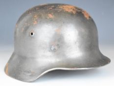 German WW2 Nazi Third Reich steel helmet stamped EE60 and 20750 to inner rim, with liner and chin
