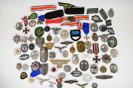 Approximately 50 German reproduction badges and insignia