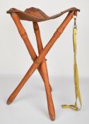 Folding leather and wood tripod shooting seat.