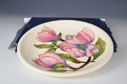 Moorcroft plaque decorated in the pink Hibiscus pattern, diameter 26cm