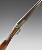 George H Daw 12 bore round hammer action shotgun with fine scrolling engraving to the lock,