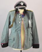 German WW2 Nazi Third Reich police tunic of green cloth with pink piping, with shoulder boards,