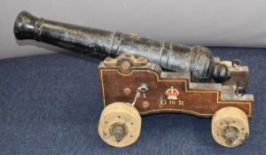 19thC cast iron signalling cannon with George III cypher and fouled anchor armorials to the carriage