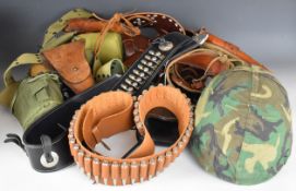 A colection of military and similar webbing and clothing including M1 helmet, belts, holsters, water
