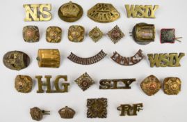 Twenty six rank insignia and shoulder titles including 22nd Motor Machine Gun Service and West