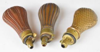 Three copper and brass pistol powder flasks including one by G & JW Hawksley, all with embossed