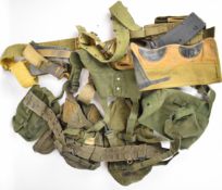 A collection of military webbing including belts, holsters, magazines etc.