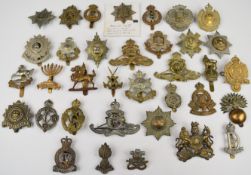 Thirty five British Army cap badges including 13th London Regiment, East Surrey, Royal Artillery