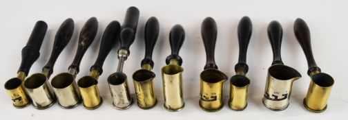 Eleven vintage gunpowder measures including G & JW Hawksley, all with turned wooden handles.