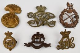 Six British Army metal badges including General's badge, Army Pay Corps, Sabretache badge, Duke of