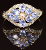 A 14k gold ring set with tanzanites and diamonds in a floral cluster, 3g, size R