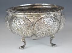Indian, Burmese or similar silver bowl with embossed decoration, raised on three feet, diameter