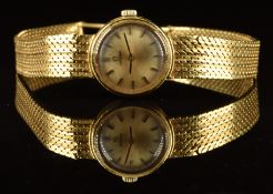 Omega 18ct gold ladies wristwatch with black hands and hour markers, champagne dial and signed 17