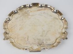 George VI hallmarked silver salver with shaped edge, raised on three scroll feet, Birmingham 1938,