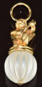 Charles Garnier 18ct gold pendant depicting a cherub playing a lute sitting on a rock crystal ridged